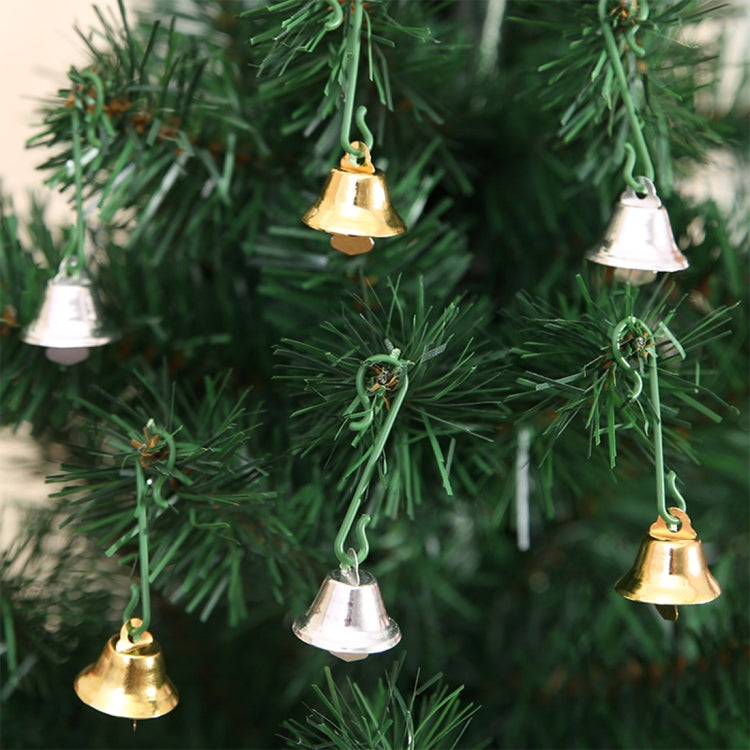 Small Christmas tree bells in gold and silver hanging on green branches