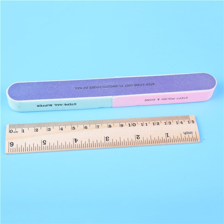 Seven-sided nail buffer bars next to a ruler for size, purple and pink