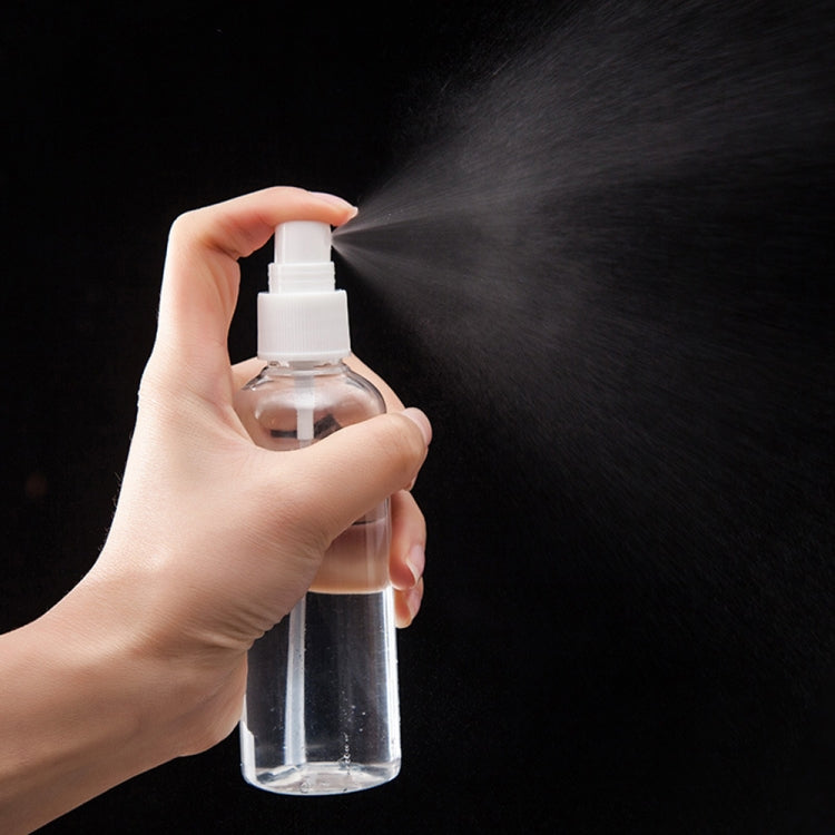 Clear PET spray bottle with white pump sprayer producing mist