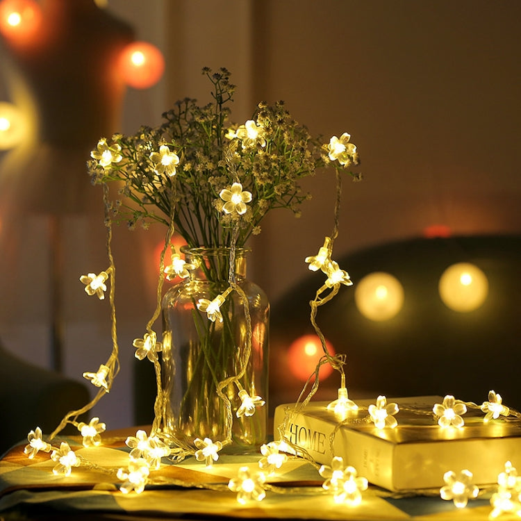Cherry blossom LED string lights with warm white flower bulbs, vase and tabletop display