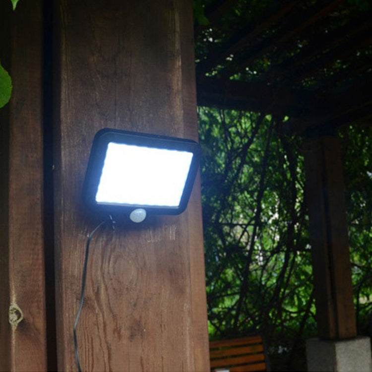 Solar wall light glowing on an outdoor wall with motion sensor