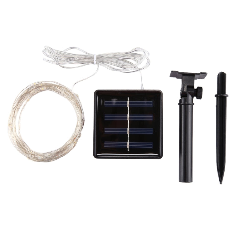 Solar string light set kit with clear wire coil, black solar panel stake, and ground stakes