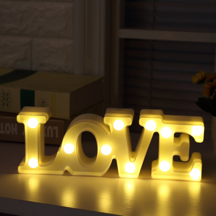 Lit warm yellow LOVE marquee table night light with glowing bulb dots