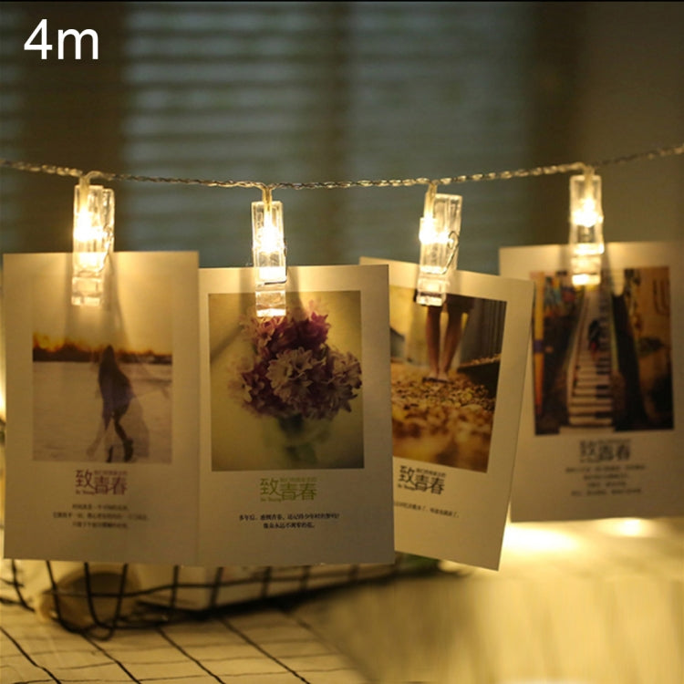 4 m warm-white LED string lights with clear photo clips holding pictures on a wire