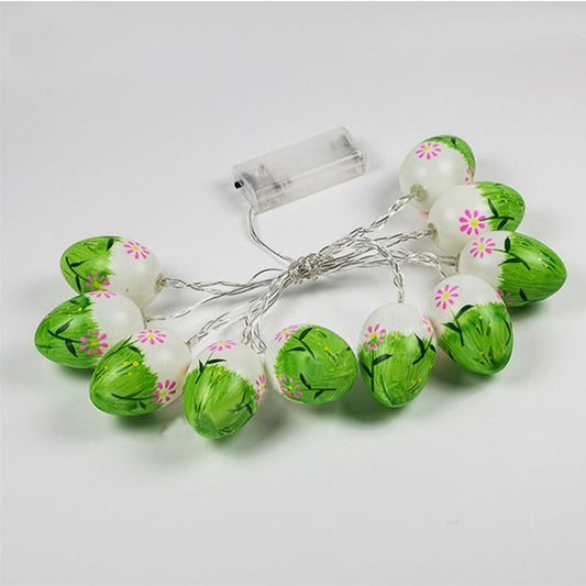 LED Easter egg string lights with green eggs and clear battery box on light background