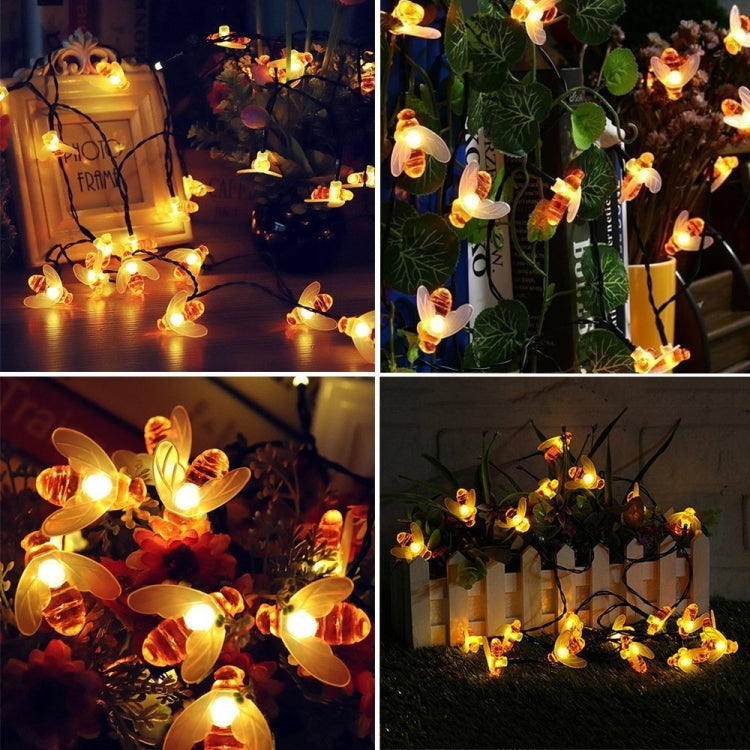 Warm white solar bee string lights glowing around outdoor plants