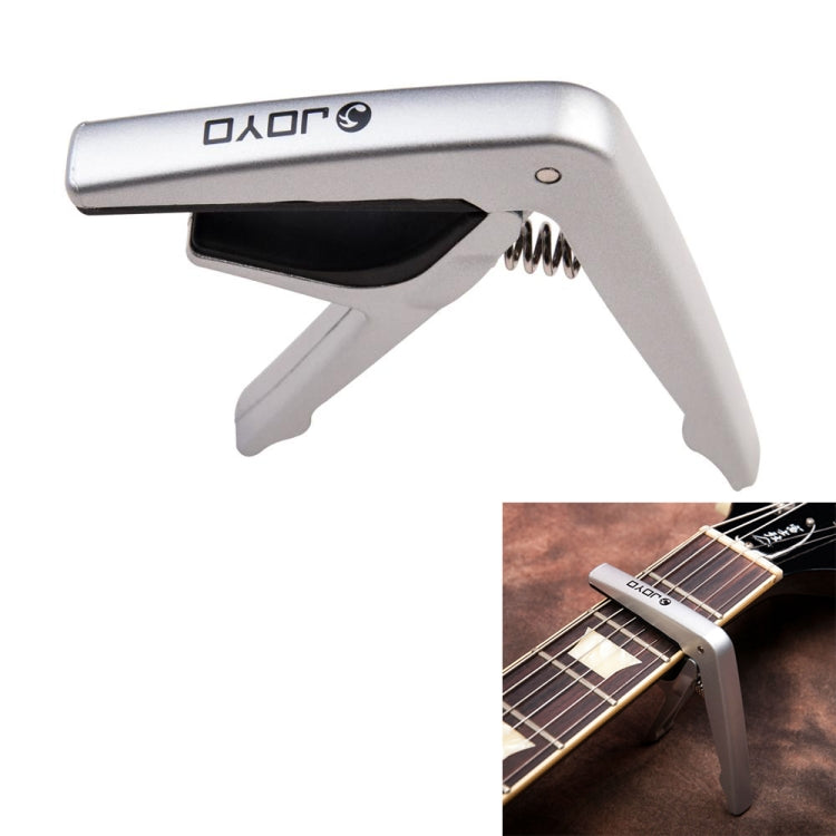 Silver capo with spring clamp and padded jaw for guitar or ukulele