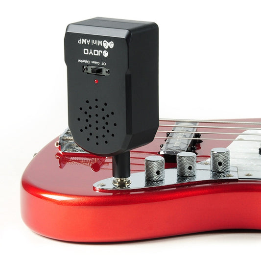 Portable mini guitar amplifier speaker with black body and perforated grille, red base