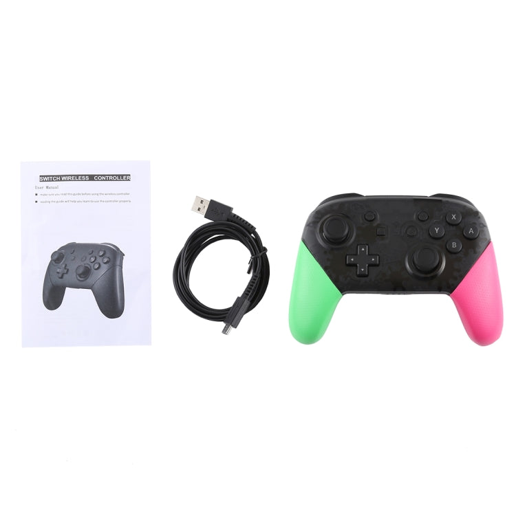 Wireless game controller with USB cable and instruction sheet, green left and pink right grips