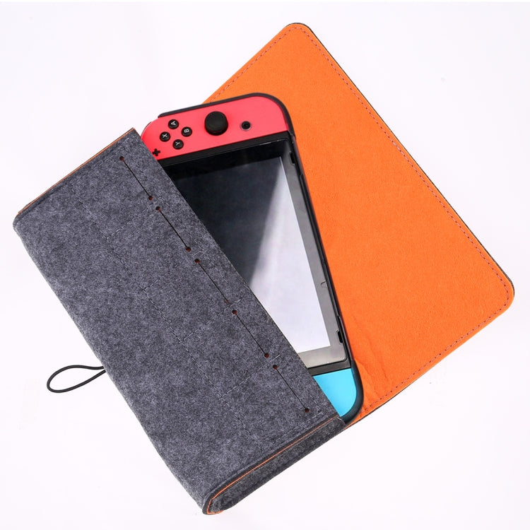 Open felt console storage bag with gray flap and orange shell, holding a handheld