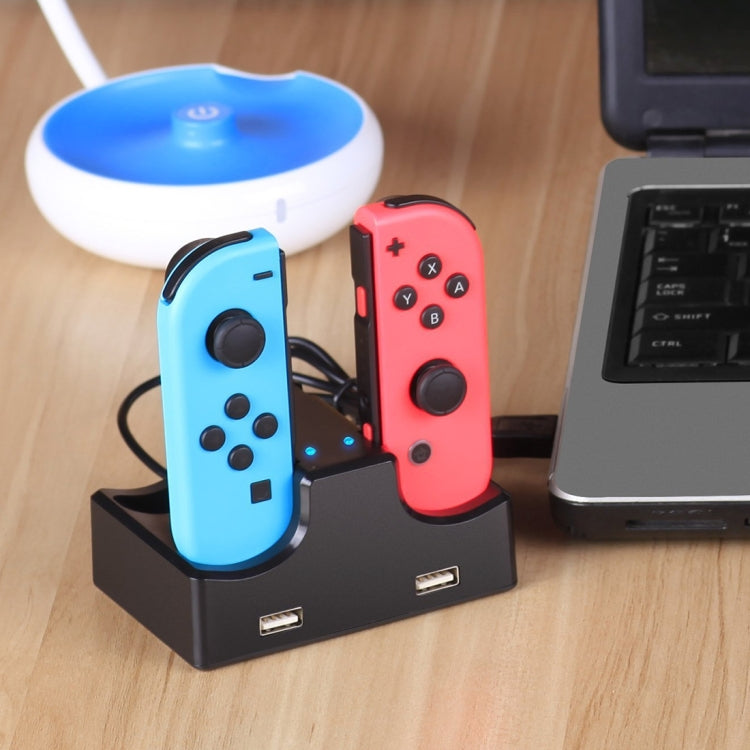 Nintendo Switch handle charging stand holding blue and red Joy-Con controllers