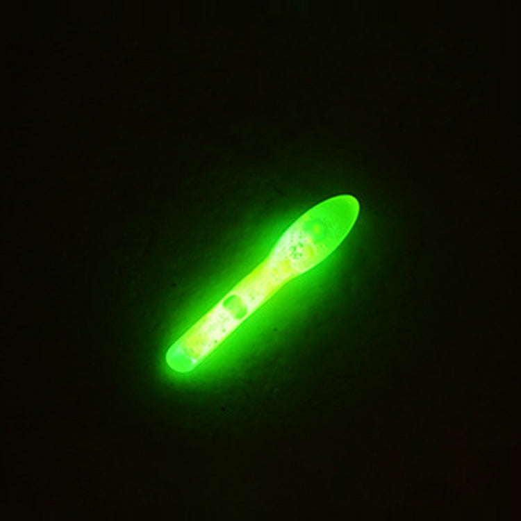 Bulb-shaped luminous fishing light stick glowing green in dark