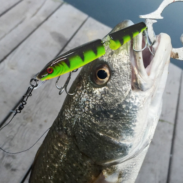 Neon green and black hard bait lure with red eye, hooked on silver fish