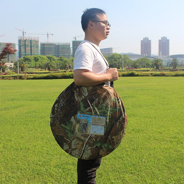 Camouflage tent carry bag held in hand for transport