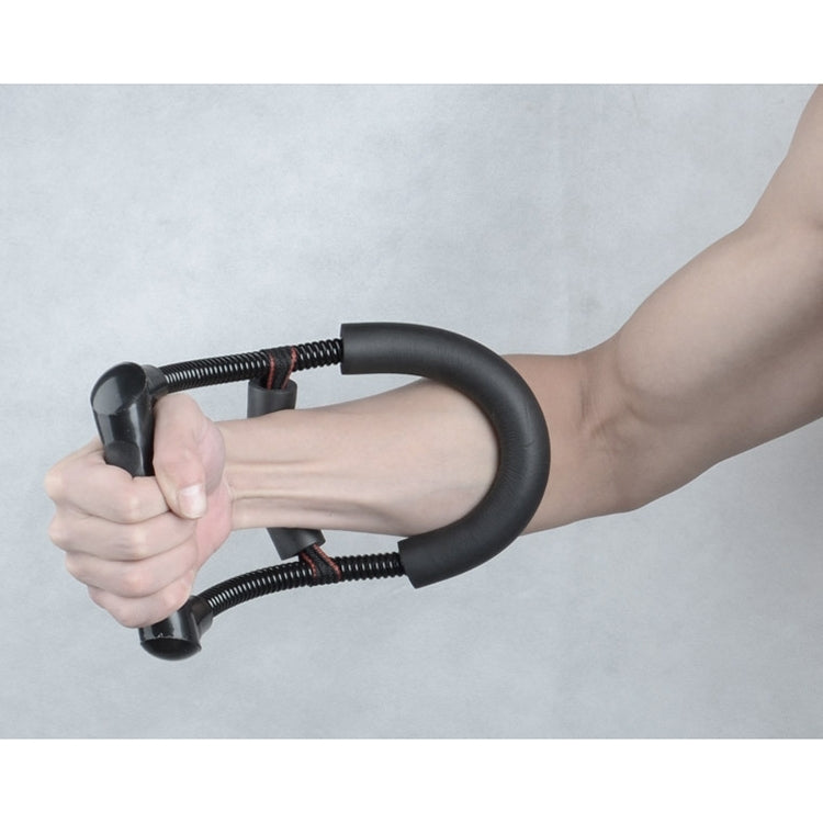 Black wrist grip trainer held in hand, foam handle loops with coiled cord