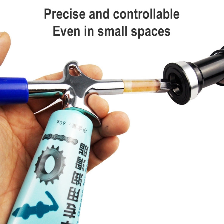 Grease gun applying lubricant to a bicycle part with black end fitting