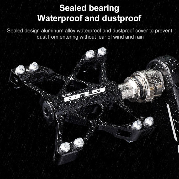 Black MTB pedals with water droplets and sealed bearing design, close-up