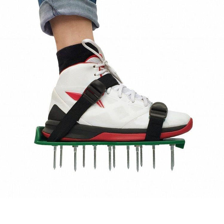 Spiked garden shoe attachment on white sneakers with green plate, black straps, and nails