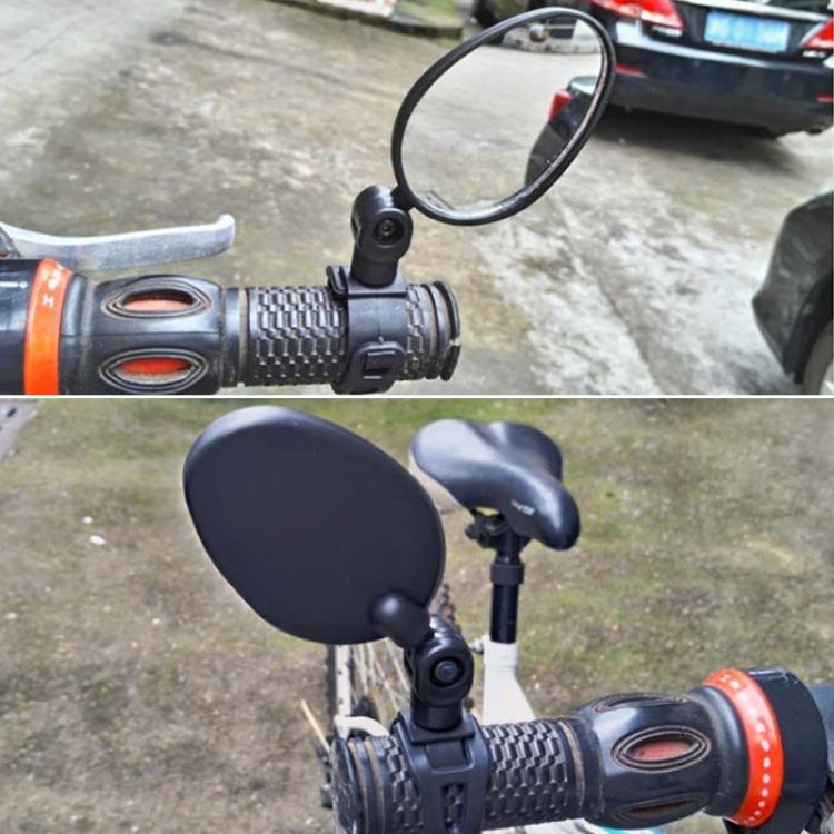 Rearview reflector mirror attached to bicycle handlebar in black oval housing
