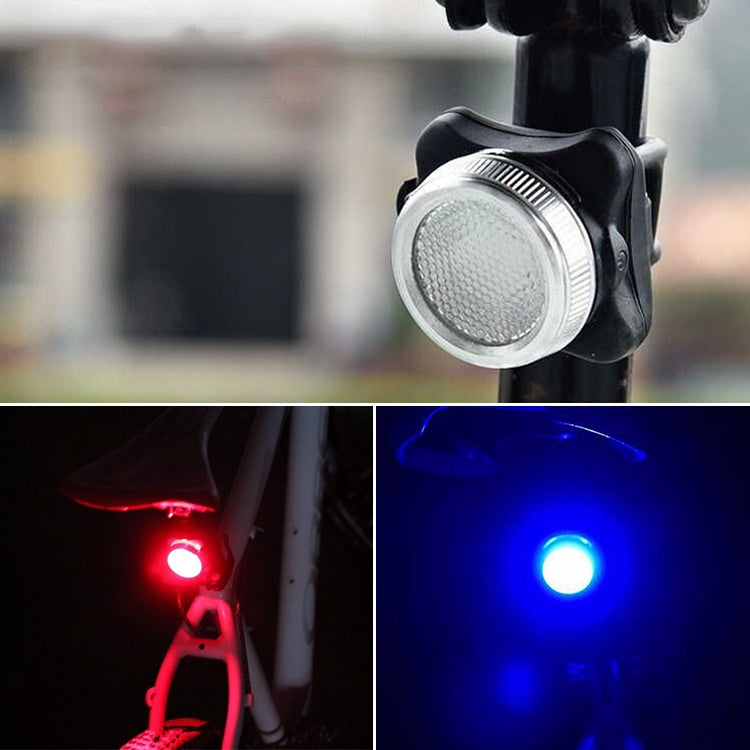 Bicycle light mounted on handlebar with white front beam and rear red/blue glow