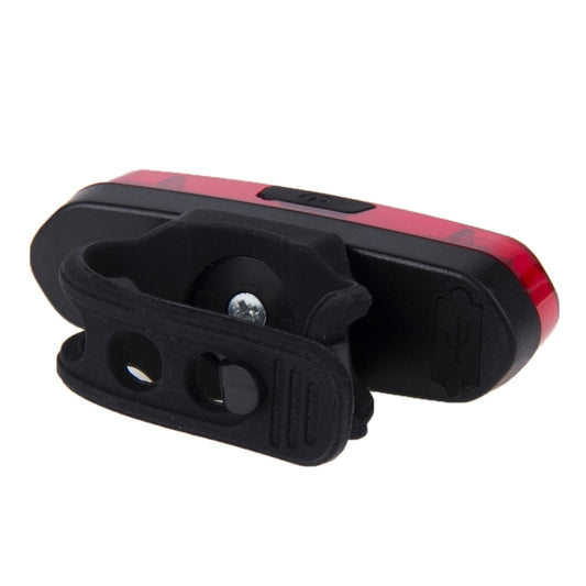 Detachable bike taillight with black mounting strap and red LED lens