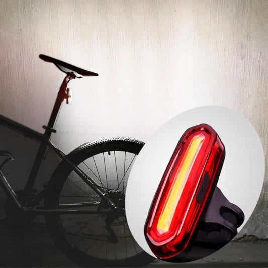Red LED bike taillight with black silicone strap and white mounting disc