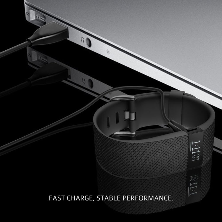Charging cable plugged into a laptop port for a fitness tracker