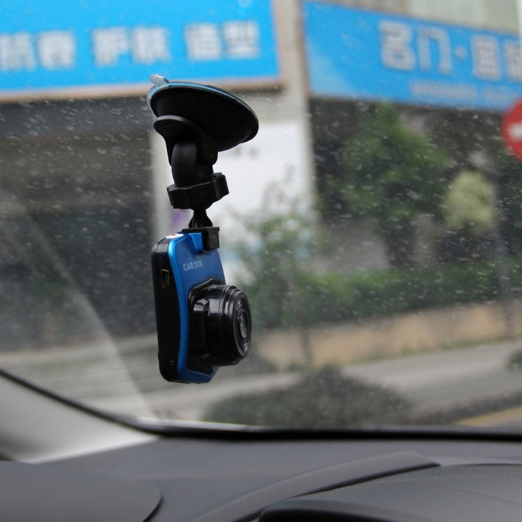 Close-up of black and blue car dash cam DVR on windshield suction mount