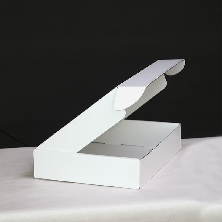 White shipping box with extended top handle flap and open interior