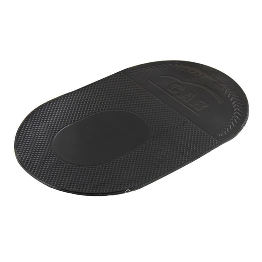 Black anti-slip sticky mat, oval shape with textured surface and central pad.