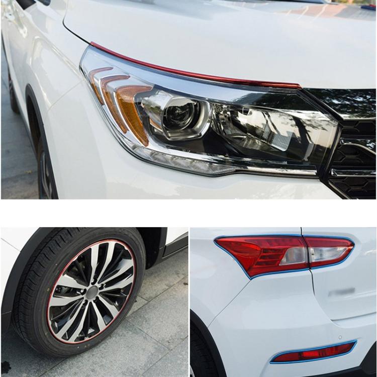 Red flexible wheel hub trim accents on car headlight, wheel, and taillight