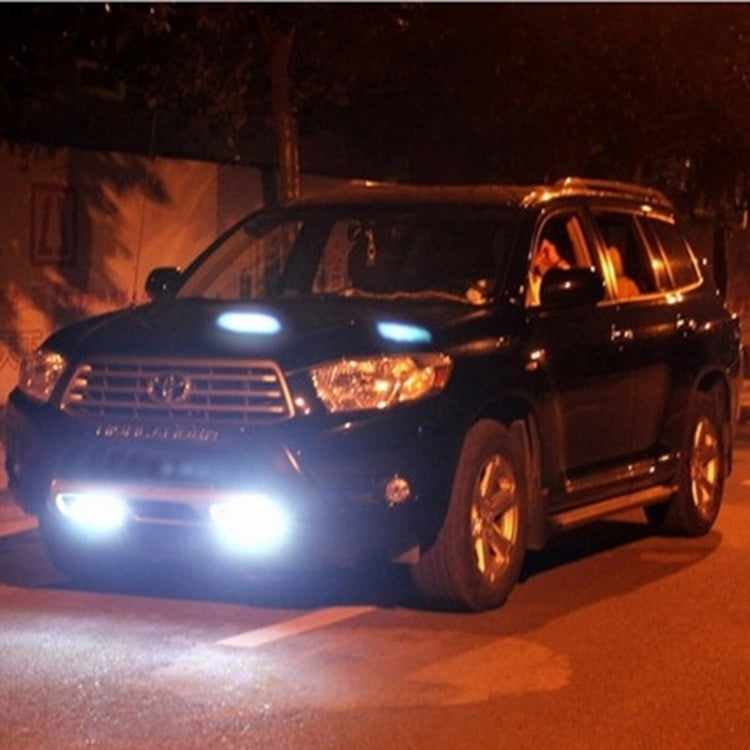 Car front with glowing white LED daytime running lights on both sides.