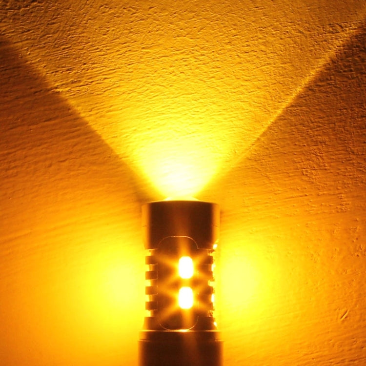 Lit 1157 LED bulb casting a warm yellow light beam from the lens opening