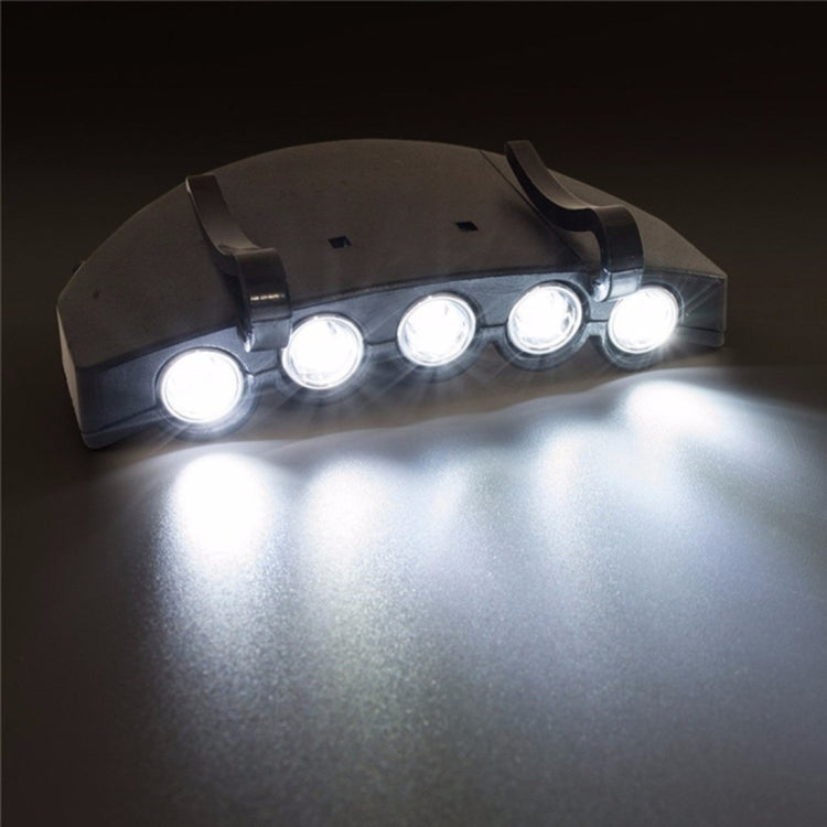 Black five-LED headlamp glowing brightly with several front LEDs lit.