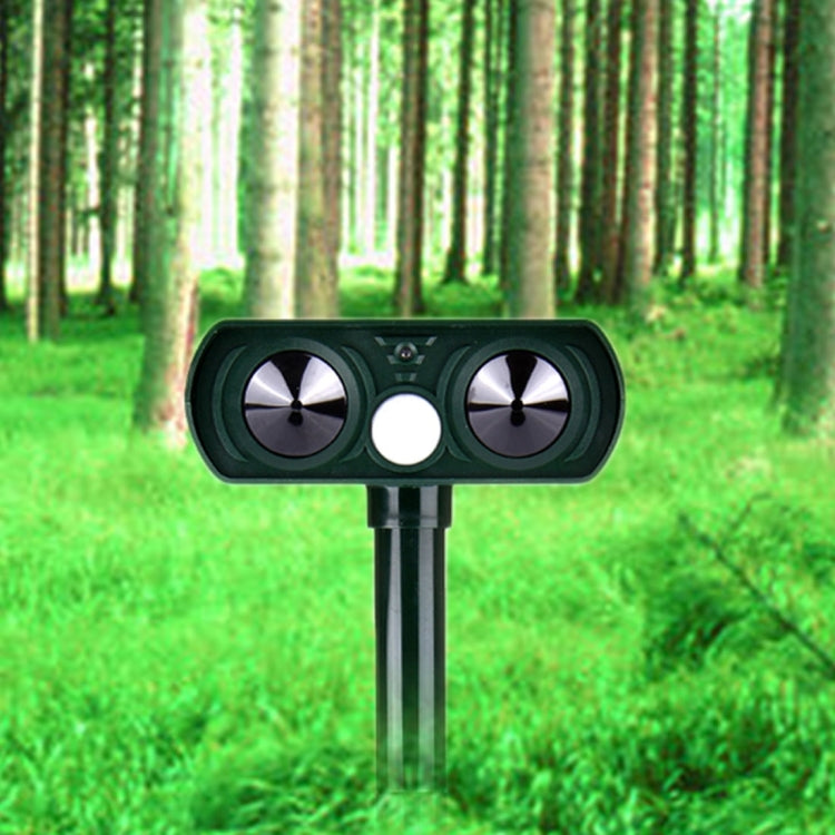Solar ultrasonic animal repeller with dual speaker grilles and metal stake, dark green.