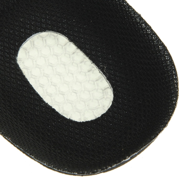 Close-up of oval white traction insert on a black orthotic insole top