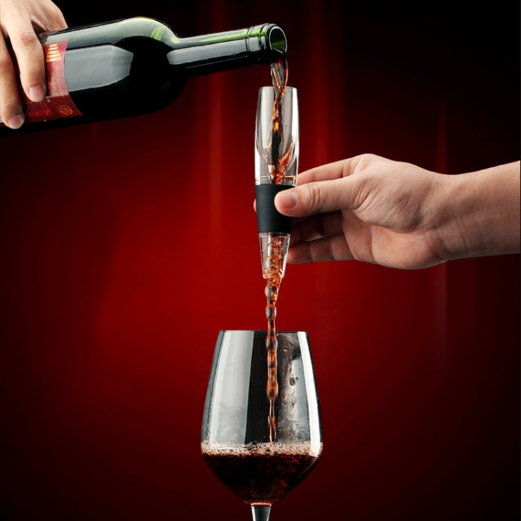 Wine pourer decanter pouring red wine into glass; clear body with black grip
