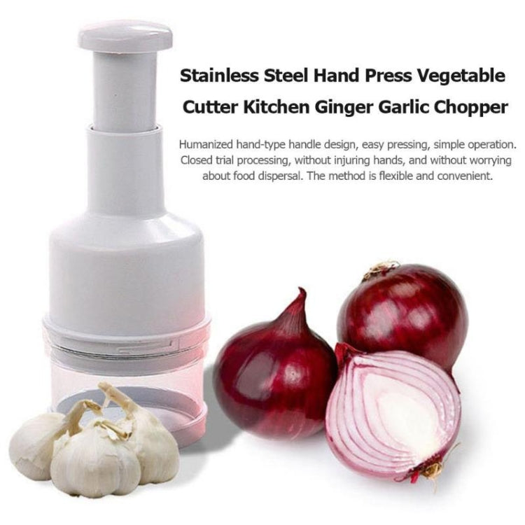 White hand-press vegetable cutter with stainless parts, shown with garlic cloves and red onions