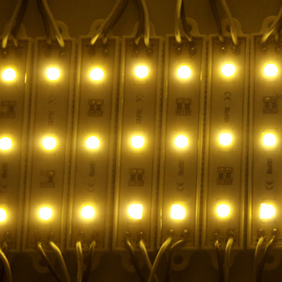 Warm white LED modules glowing in a row, showing multiple bright light points