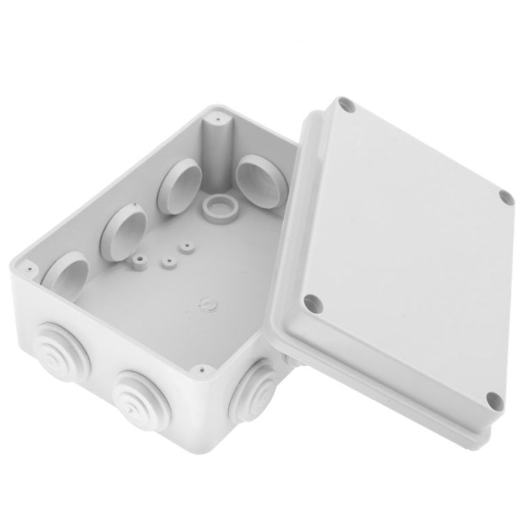 White plastic waterproof junction box open, showing inner ports and removable lid