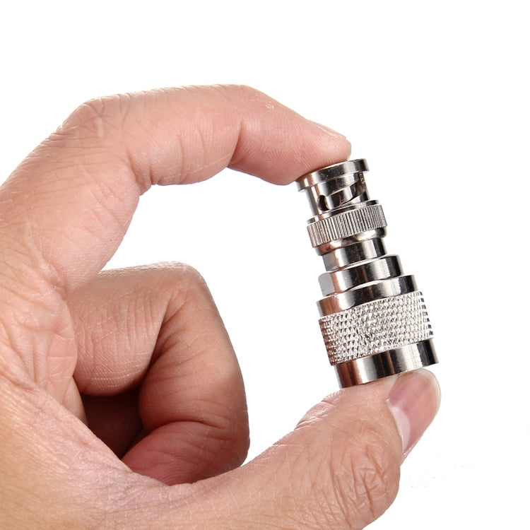 N to BNC male RF connector in hand, textured metal grip and stacked rings