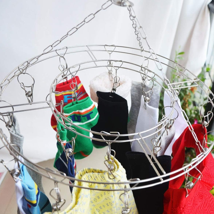 Close-up stainless steel clothes clip hanger holding socks and other garments on clips