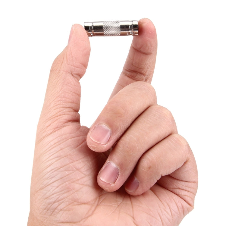 BNC female-to-female adapter connector held in hand, metal cylindrical design