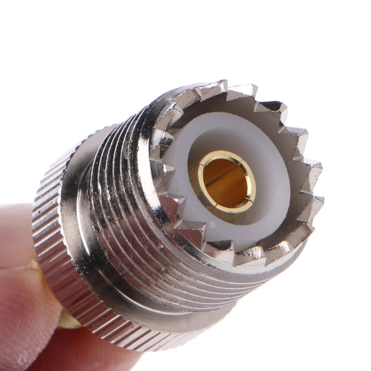 RF coaxial connector close-up, SMA female socket with gold center ring and serrations
