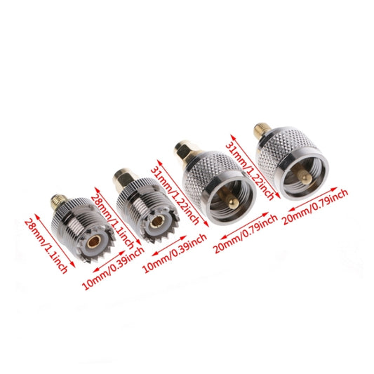 Four RF adapters laid out, silver knurled housings with brass contact inserts