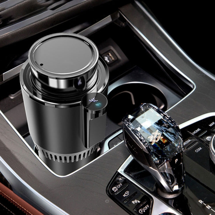 Black mini car cup cooler in vehicle console with open top and glowing control display