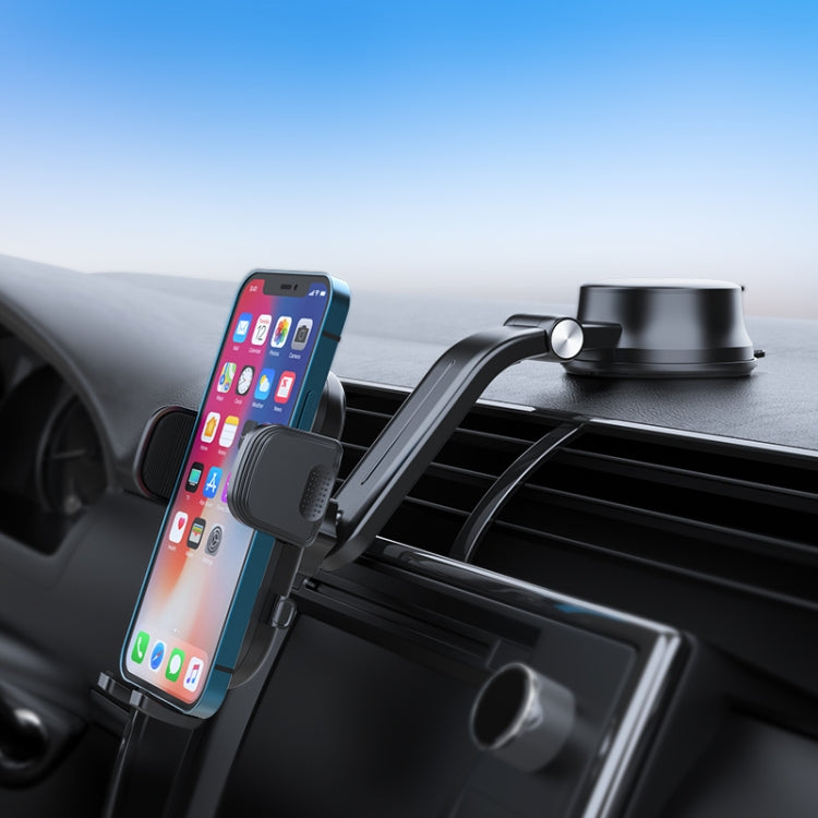 Car dashboard phone holder gripping a smartphone on the air vent with clamp arms