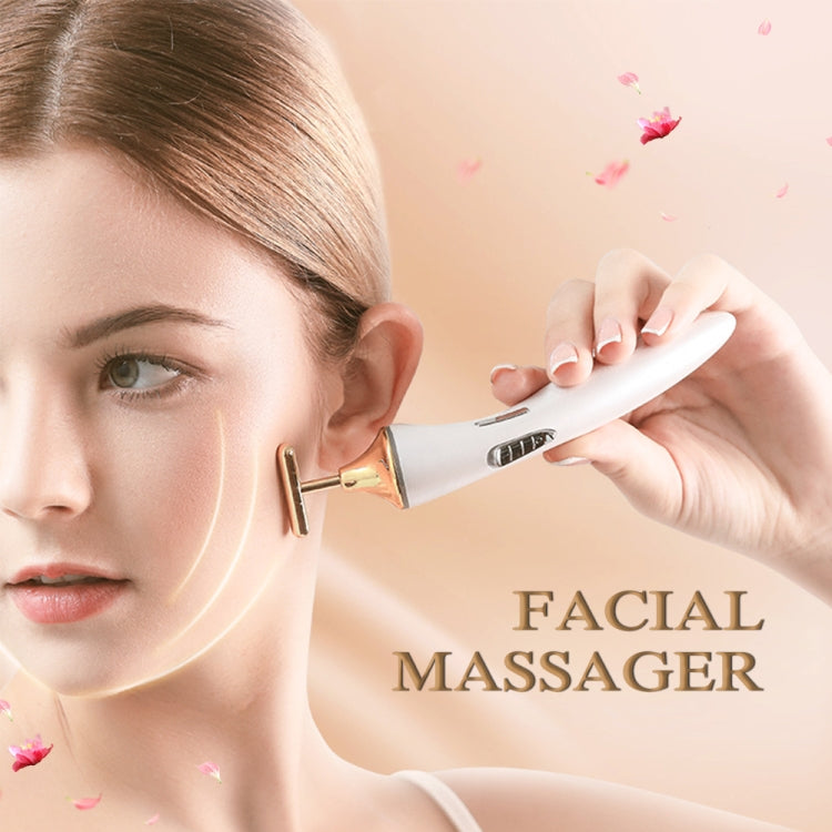 Electric facial massager being used on the face with white and gold head