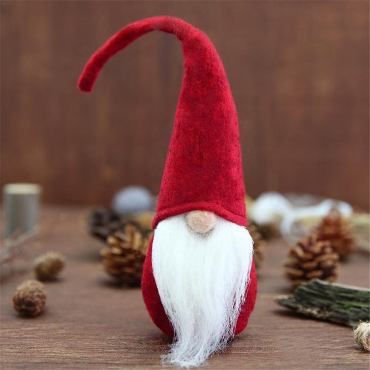 Red felt mini Santa gnome decoration with white beard and curved brim hat.