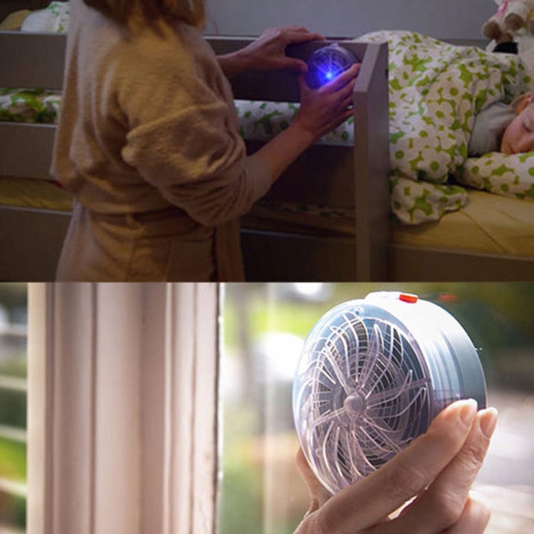 Handheld solar mosquito zapper with glowing UV bulb in round fan housing